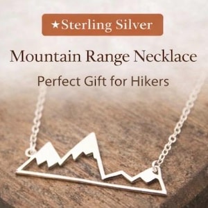 May include: Sterling silver mountain range necklace. The necklace features a delicate chain and a pendant shaped like a mountain range. The text "Mountain Range Necklace" is displayed above the pendant.