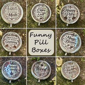 May include: A collection of silver-colored, round pill boxes with various humorous phrases and designs. The boxes feature text like "Happy Pills," "Weed," and "Magic Beans." The image also includes the text "Funny Pill Boxes."
