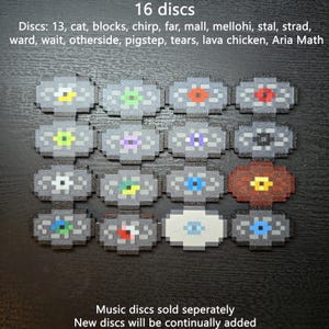 May include: A collection of 16 pixelated music discs arranged in a grid. The text reads: 16 discs, Discs: 13, cat, blocks, chirp, far, mall, mellohi, stal, strad, ward, wait, otherside, pigstep, tears, lava chicken, Aria Math, Music discs sold seperately.