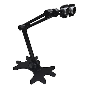May include: Black adjustable desk microphone stand with a star-shaped base. The stand has two arms that can be adjusted to different angles. The microphone is not included.