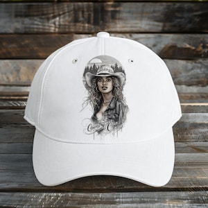 May include: White baseball cap with a black and white illustration of a woman in a cowboy hat and denim jacket. The cursive text "Country Chic" is below the image. The cap has a curved brim.