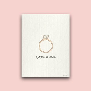 May include: A white card with a simple line drawing of a diamond engagement ring and the text "CONGRATULATIONS".