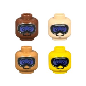 May include: Four Lego minifigure heads in various skin tones and a yellow head. Each head features a blue goggle design and a small black smile. The heads are for Lego building sets.