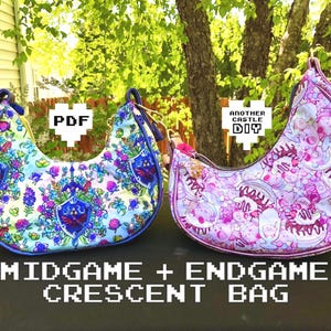 May include: Two crescent-shaped bags featuring colorful patterns. The left bag has a blue and floral design with shield motifs. The right bag has a pink and purple pattern with character illustrations. Text reads: PDF, ANOTHER CASTLE DIY, MIDGAME + ENDGAME CRESCENT BAG.