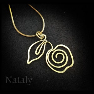 May include: A gold necklace with a pendant featuring a stylized rose and leaf design. The pendant is made of wire and has a delicate, intricate look.