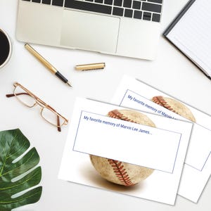 May include: Two white cards with a baseball graphic and the text "My favorite memory of Marvin Lee James..." printed on them.
