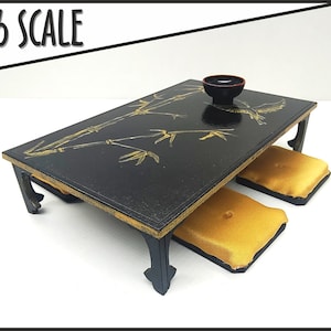 May include: A black table with a gold bamboo design and a small black bowl. The table has two gold cushions. 1/6 Scale.