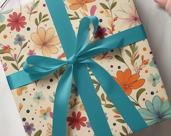 May include: A gift box wrapped in cream-coloured paper with a floral pattern in orange, pink, and blue. A teal ribbon is tied in a bow around the box. The gift is ready to be given.