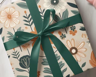 May include: A wrapped gift with floral patterned paper in beige, orange, and teal. The gift is tied with a dark green satin ribbon and bow. The floral design includes large daisies and other stylized flowers.