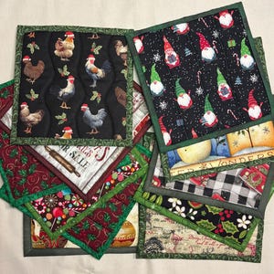 May include: A collection of quilted Christmas-themed pot holders. Designs include chickens wearing Santa hats, gnomes, and holiday patterns. Each pot holder has a green border and various festive prints, perfect for kitchen decor.