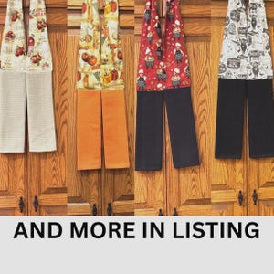 May include: Four hanging kitchen towels with patterned fabric tops and solid-colored waffle-weave bottoms. The designs feature apples, vegetables, chefs, and farm animals. The text AND MORE IN LISTING is displayed at the bottom of the image.