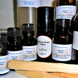 May include: A collection of amber glass bottles with black caps containing essential oils. The bottles are labeled with the text "Product Name", "100% Pure Essential Oil", "Steam Distilled", "Hand Origin China", and "Order Dated".