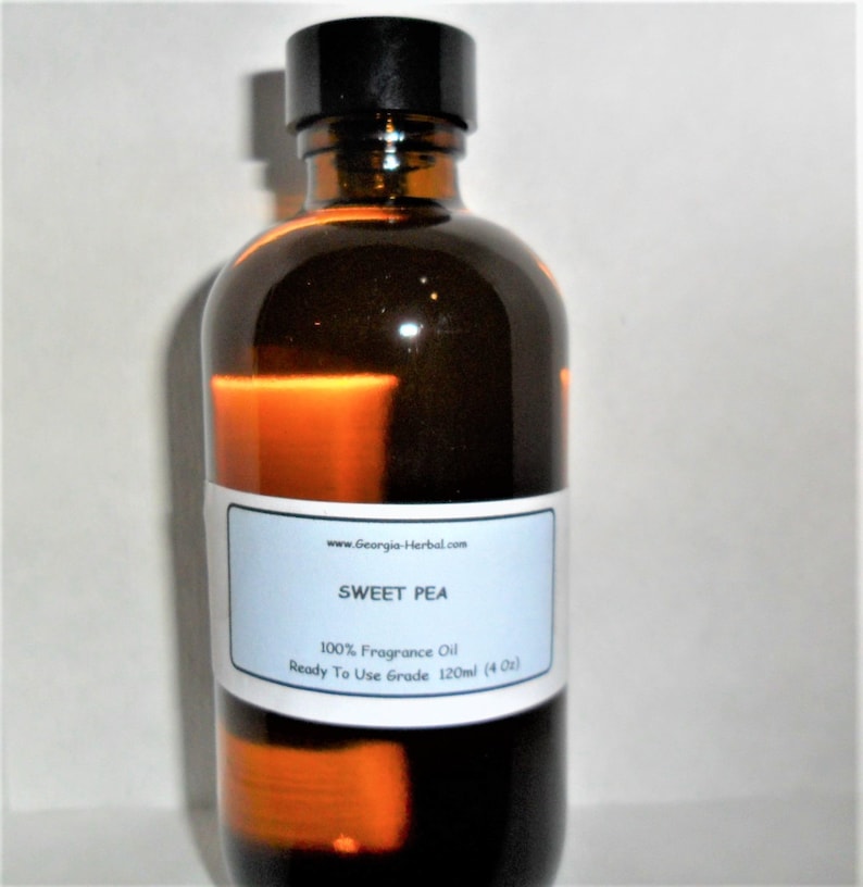 May include: A brown glass bottle with a black cap, labeled "SWEET PEA 100% Fragrance Oil Ready To Use Grade 120ml (4 oz)".