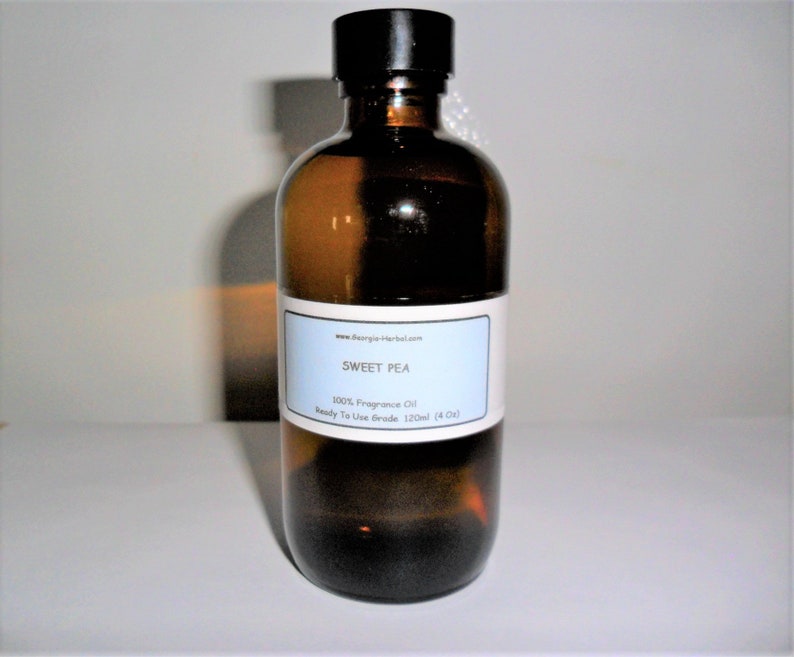 May include: A brown glass bottle with a black cap, containing a clear liquid. The label reads "SWEET PEA 100% Fragrance Oil Ready To Use Grade 120ml (4 fl oz)"