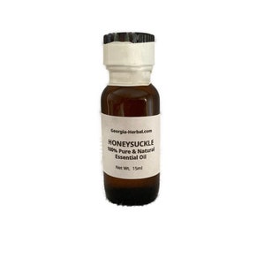 May include: A small brown glass bottle with a white label that reads "Honeysuckle 100% Pure & Natural Essential Oil Net Wt. 15ml Georgia-Herbal.com"