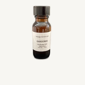 May include: A small brown glass bottle with a black cap. The label reads "Georgia-Herbal.com GARDENIA Perfume Oil 100% Pure Net Wt. 15ml."