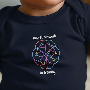 May include: A dark navy blue short-sleeved baby bodysuit featuring a colorful graphic of a brain-shaped neural network with interconnected nodes and lines. The text "neural network" appears above the graphic and "in training" below it in white.