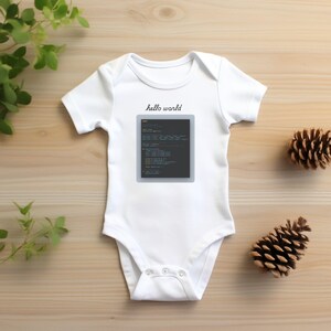 a baby's bodysuit sitting on top of a wooden table