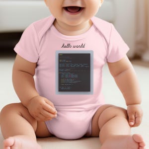 a baby sitting on the floor with a computer screen on it's chest