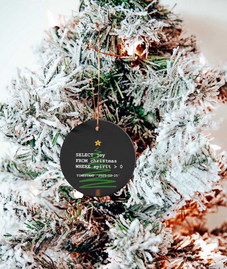 A Christmas tree decorated with ornaments, including a round ornament with text that reads "SELECT joy FROM christmas WHERE spirit = 0 TIMESTAMP: 2020-12-23".