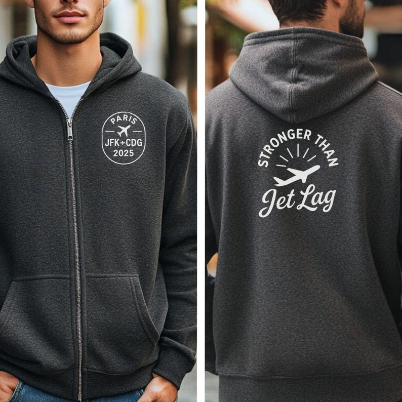 A man wearing a grey hooded sweatshirt with white text and graphics on the back.