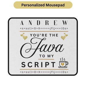 May include: A personalized mousepad with a black border and a white surface. The mousepad features the name "Andrew" above the text "You're the Java to my Script." Gold hearts and a coffee cup graphic are also included.