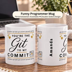 May include: A white ceramic mug featuring black and gold text that reads You're the Git to my COMMIT. The design includes small gold hearts, a code bracket icon, and a border of git status, git add, git commit, git push, and git log commands.