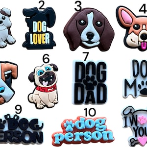 May include: Ten colourful, cartoon-style dog-themed iron-on patches. The patches feature various dog breeds, including a bulldog, a pug, a beagle, and a corgi. The patches also feature text such as "Dog Lover", "Dog Dad", "Dog Mom", and "Dog Person".