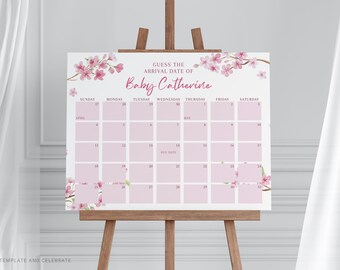 May include: A rectangular sign featuring a calendar grid for April and May with the text GUESS THE ARRIVAL DATE OF Baby Catherine. The design includes pink cherry blossom branches in the corners and light pink squares for each day.