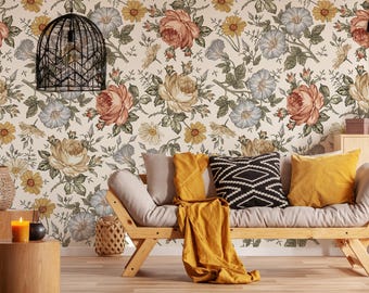 May include: A light beige sofa with a floral patterned wallpaper behind it. The sofa has a yellow throw blanket and three cushions, one black and white geometric patterned cushion and two solid yellow cushions.