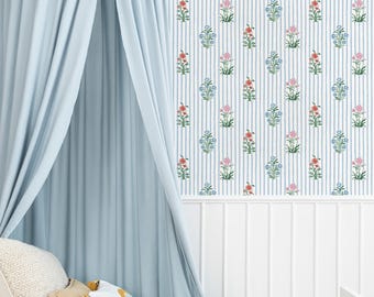 May include: A light blue canopy bed with a floral patterned wallpaper background. The wallpaper features vertical stripes with repeating floral designs in red, pink, and blue. The bed is made up with pillows and a yellow blanket.