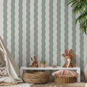 May include: A children's room scene featuring a teepee, a white shelf with decorative items, and a palm tree. The wall has a wavy striped pattern in white and light green. Soft toys and a woven basket add to the cozy atmosphere.