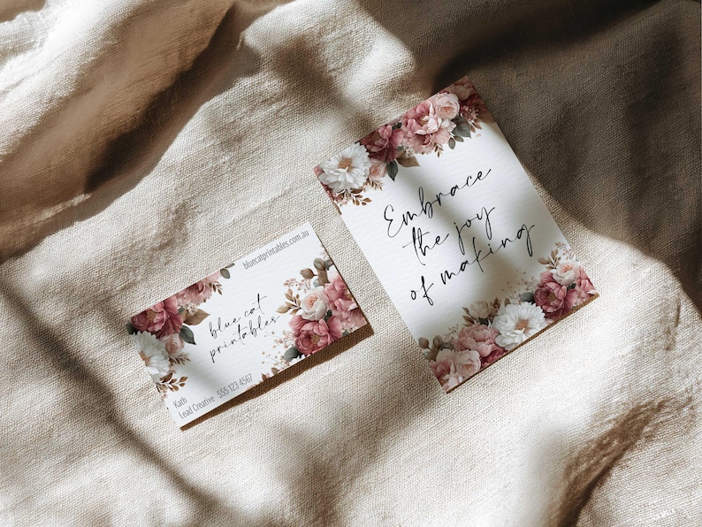 May include: Two cards with floral designs. One card reads "Embrace the joy of making" in script. The other card has the text "blue cat printables" and contact information. Both cards feature pink and white flowers.