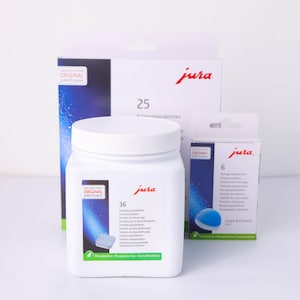 May include: A set of three ceramic mugs with a speckled, matte finish. The mugs are in shades of cream, light gray, and dark gray. Each mug has a simple, minimalist design, perfect for coffee or tea.