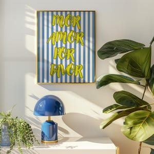 May include: A blue and white striped poster with the text "MOR AMOR POR FAVOR" in yellow lettering.