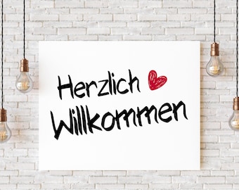 May include: White sign with black text that says "Herzlich Willkommen" with a red heart drawn next to the word "Herzlich". The sign is hanging from the ceiling with light bulbs hanging from the ceiling on either side of the sign.