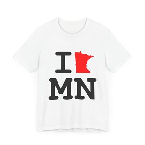 May include: White t-shirt with a black graphic that says "I love MN" with a red outline of the state of Minnesota.