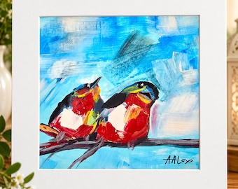Könnte beinhalten: Ein quadratisches gerahmtes Gemälde zeigt zwei Vögel mit rotem, weißem und schwarzem Gefieder, die auf einem Ast vor einem strukturierten blauen Hintergrund sitzen. Das Kunstwerk zeigt sichtbare Pinselstriche und die Signatur AAL unten rechts.