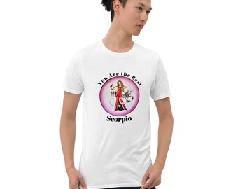 May include: White t-shirt with a circular graphic. The graphic has the text "You Are the Best" and "Scorpio", along with an illustration of a woman in a red dress and a scorpion. The t-shirt is worn by a person.