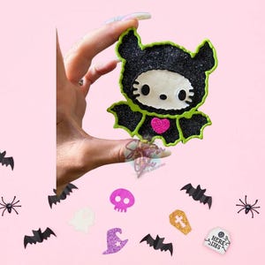 Kitty in bat costume
