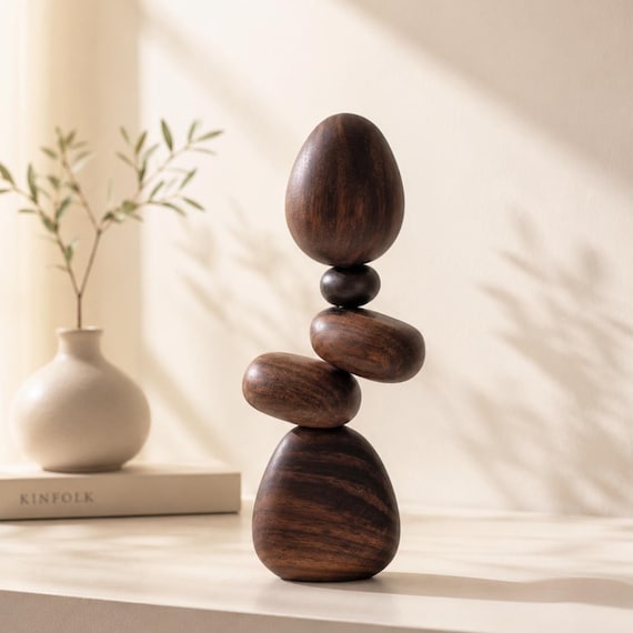 Solid walnut 'stones' that balance magnetically — looks like impossible stacking art but anyone can do it, and 388 favorites don't lie.