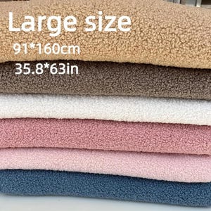A stacked pile of fuzzy teddy fleece fabric in various colors with text overlay stating Large size 91 160cm 35.8 63in.