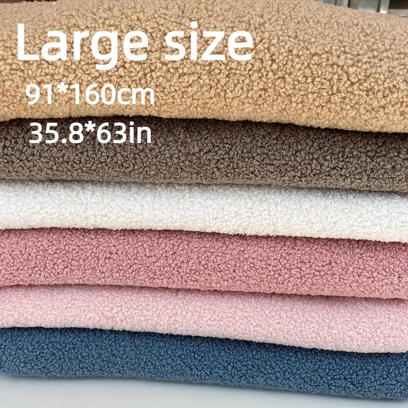 A stacked pile of fuzzy teddy fleece fabric in various colors with text overlay stating Large size 91 160cm 35.8 63in.