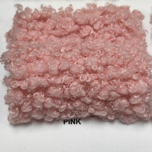 A square swatch of pink curly teddy fleece fabric with the word PINK printed below.
