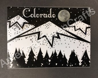 May include: Black and white Colorado-themed art print featuring a mountain range, a full moon, and a forest of pine trees. The word "Colorado" is written in a decorative font across the top of the image.