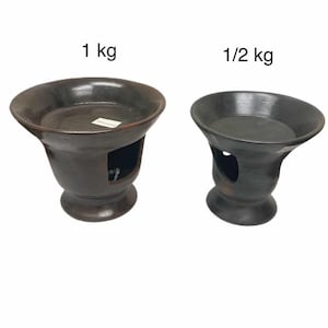 May include: Two dark brown ceramic bowls with a pedestal base and a circular opening on the side. The larger bowl is labeled "1 kg" and the smaller bowl is labeled "1/2 kg". The bowls have a smooth, glossy finish.
