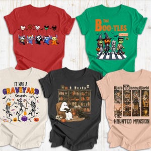 May include: Five Halloween-themed t-shirts in red, green, cream, black, and peach. Designs include cartoon characters, the text "The Boo-tles", and "It Was a Graveyard Smash". One shirt features "The Haunted Mansion" from Walt Disney World.