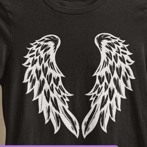 May include: Black t-shirt featuring a white angel wing design. The shirt is hanging on a wooden hanger. The words "Digital Download" are in a purple circle in the upper left corner. The bottom of the image has the words "svg eps dxf png jpg".
