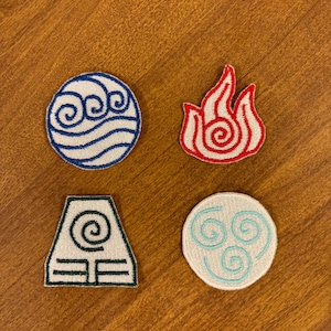 May include: Four embroidered patches featuring the elemental symbols from the animated series Avatar: The Last Airbender. The symbols are water, fire, earth, and air. The patches are white with blue, red, green, and light blue embroidery.