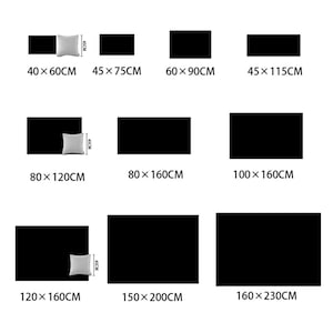 以下が含まれることがあります： 長方形のクッションと毛布のサイズを比較した表です。表には、各アイテムの寸法がセンチメートルで表示されています。表には、各アイテムの寸法がセンチメートルで表示されています。